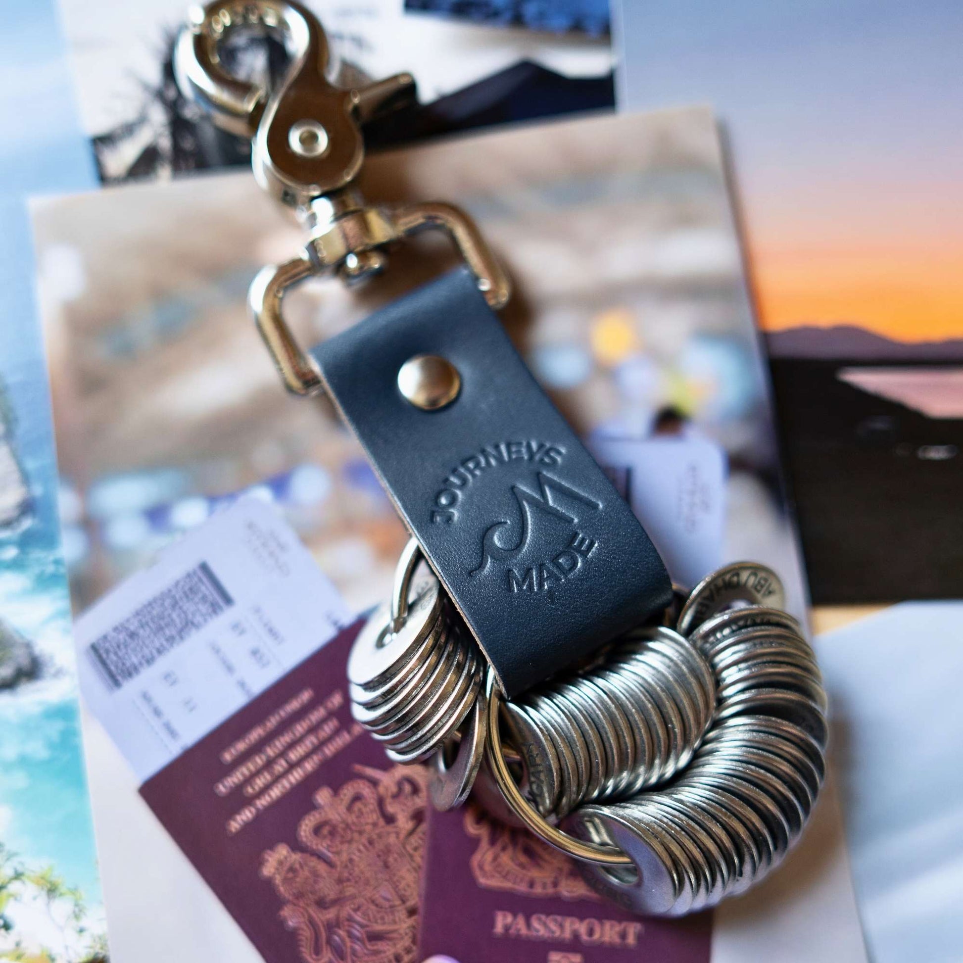 ocean blue travel gift consisting of leather travel keyring and engraved travel tokens on the split ring, holding 38 engraved tokens in stainless steel on printed holiday photos