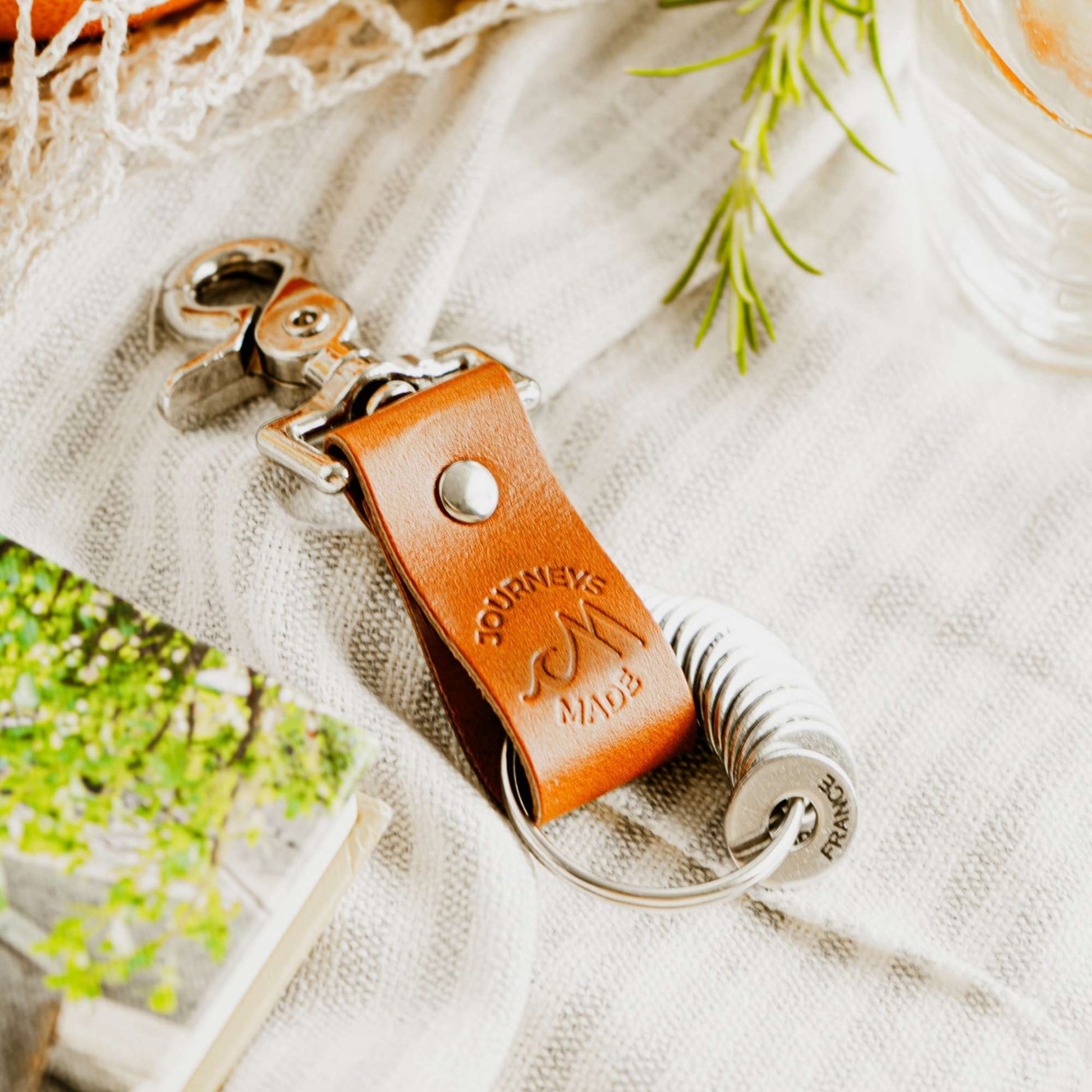 Tan travel keyring made from vegetable-tanned leather, perfect for travel gifts and adventures.