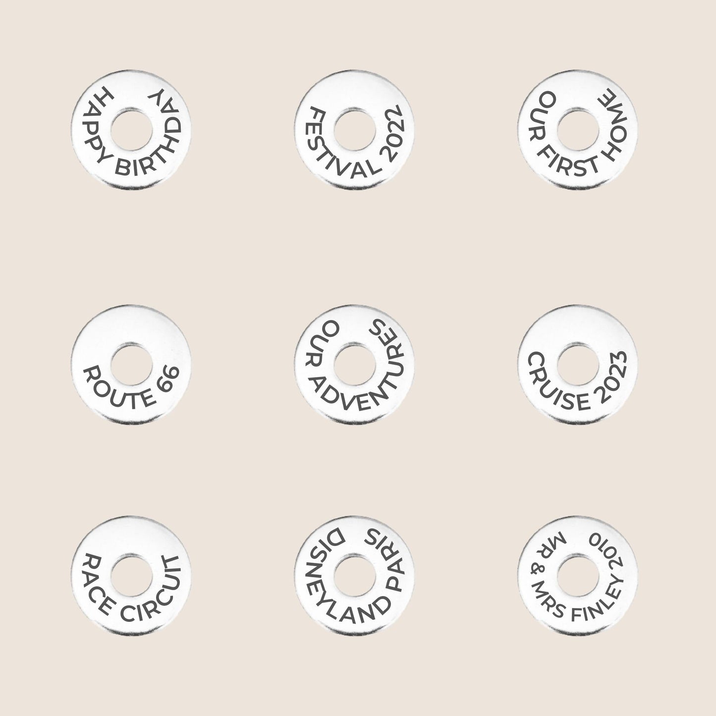 Personalized tokens with various travel and celebration messages, great for keychains or travel gifts.