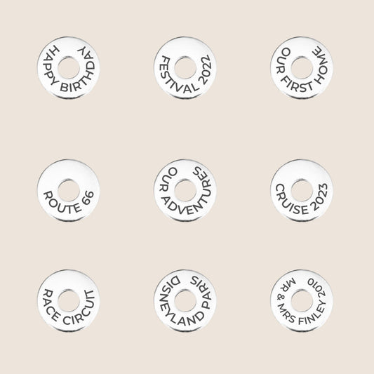 Personalized tokens with various travel and celebration messages, great for keychains or travel gifts.