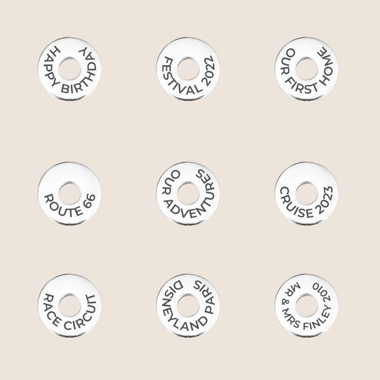 Personalized tokens with various travel and celebration messages, great for keychains or travel gifts.