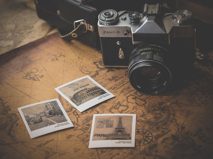 vintage camera with polaroid photos of travels around the world