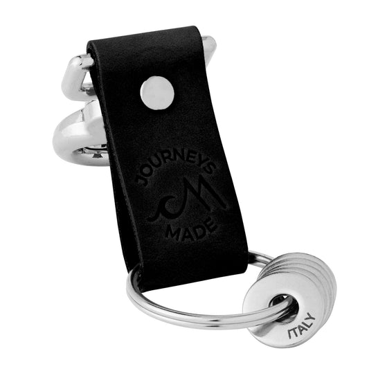 black travel gift with leather travel keyring and engraved travel tokens on a white background