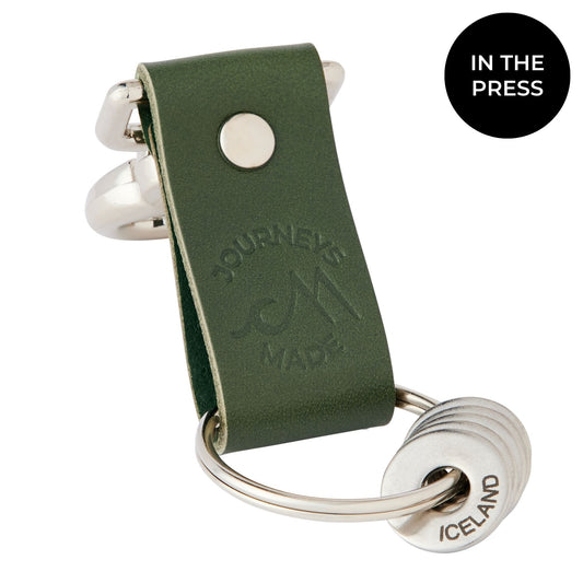 forest green travel gift with leather travel keyring and engraved travel tokens on a white background with a black circle saying 'In The Press'